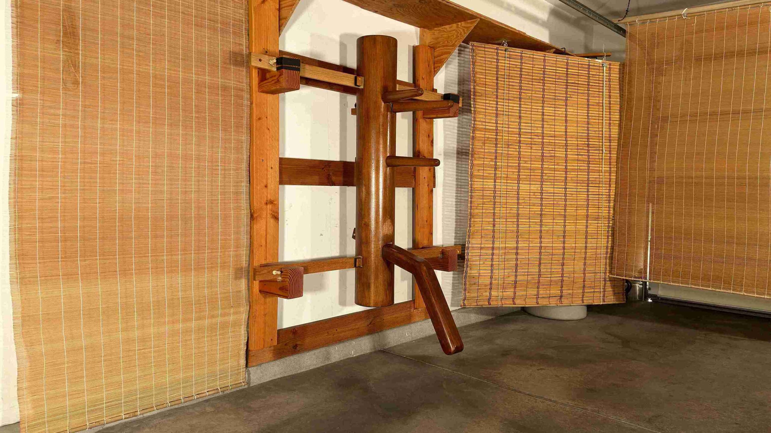 Traditional Wing Chun training hall with wooden dummy and bamboo backdrop